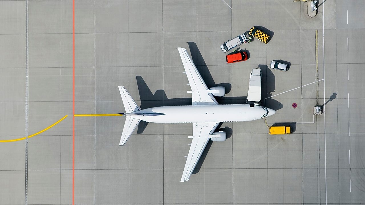 Aerial view of airplane and vans