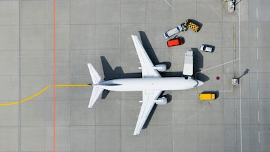 Aerial view of airplane and vans