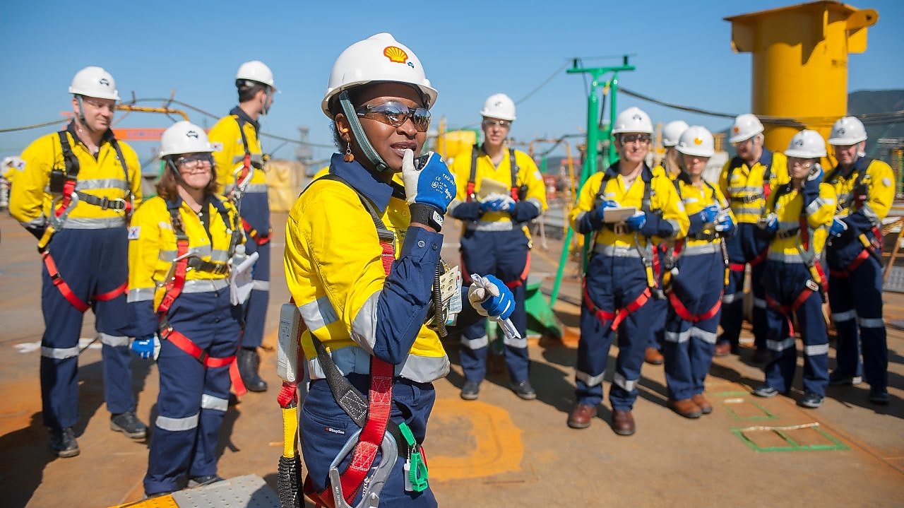 A female Shell engineer leading her team at an operational site.
