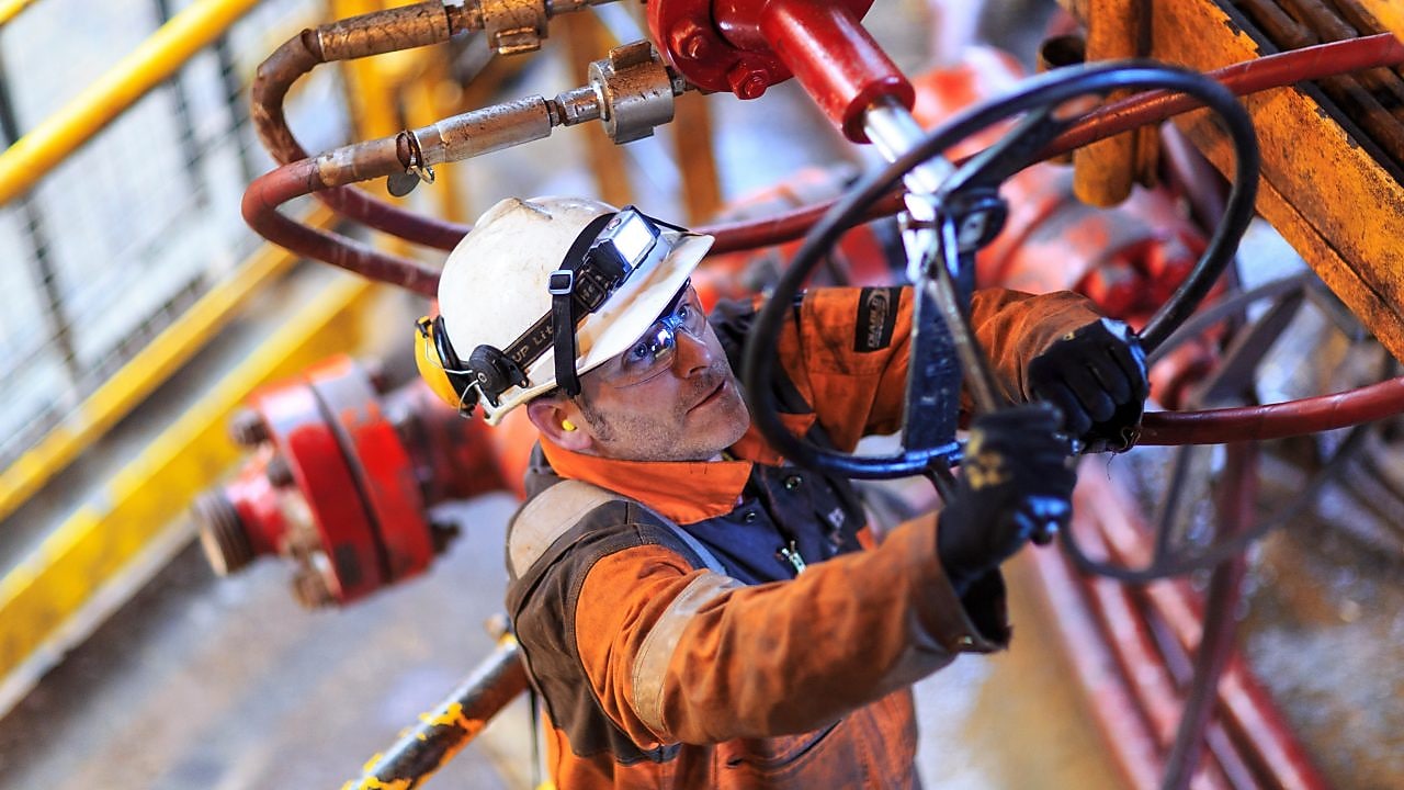 Hombre trabajando en una plataforma con el uniforme de seguridad completo