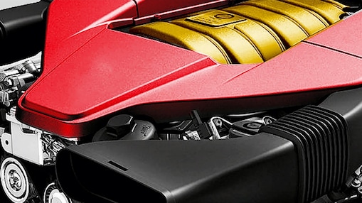 Motor de un auto, con núcleo amarillo y embellecedor rojo