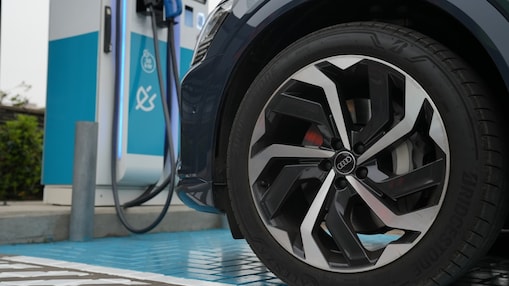 Neumático de auto con cargador Shell Recharge de fondo